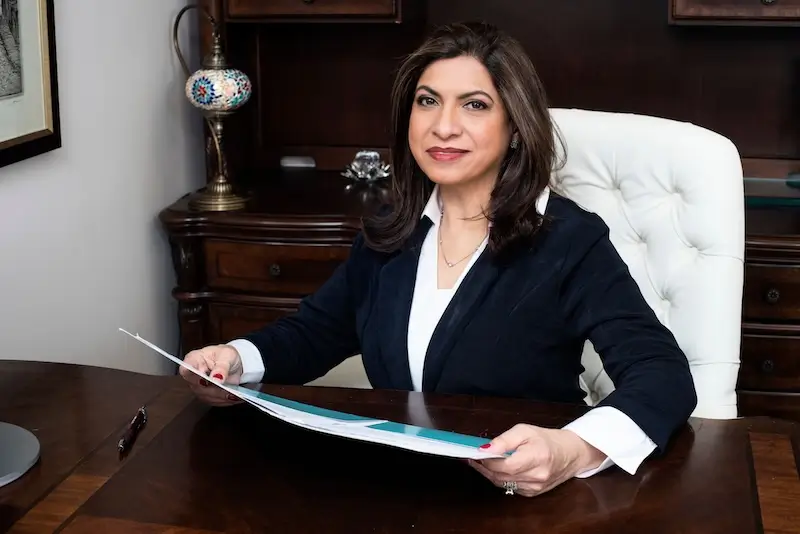 dinar sajan sitting at her facility